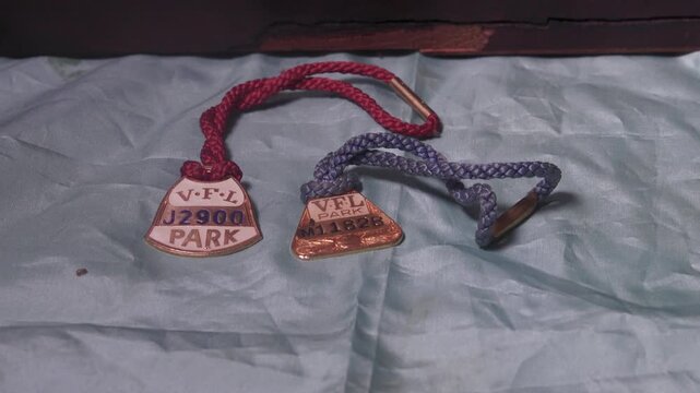 Collection of vintage VFL Park tags on a textured fabric surface. Ideal for historical or memorabilia-themed projects.