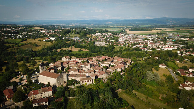 Aerial view of a walled medieval village, with its church, surrounded by lush green countryside, Perouges, Auvergne-Rhone-Alpes, France.