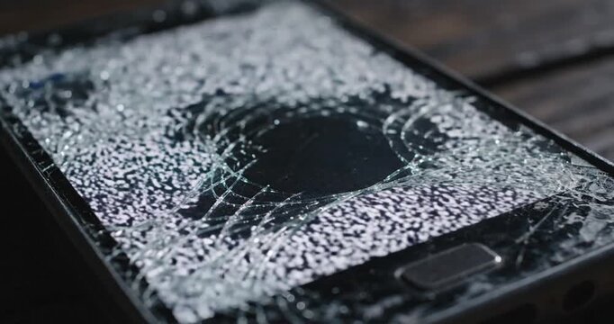Cracked smartphone screen closeup detail.