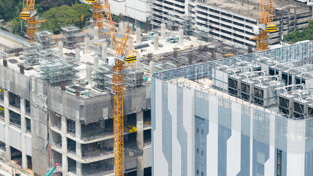 Aerial view of the STT Bangkok 1 data center under construction with yellow tower cranes and industrial cooling units Krung Thep Maha Nakhon, Thailand.