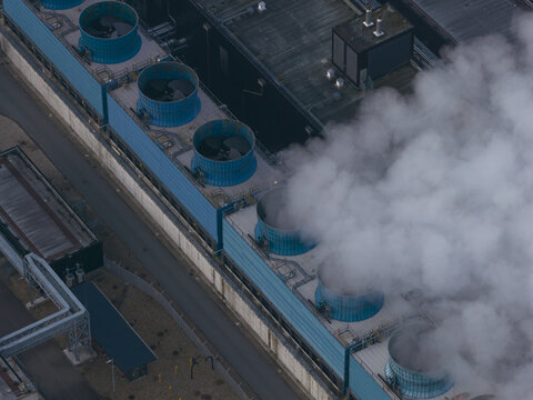 Aerial view of data center cooling towers sending steam to sky, Netherlands