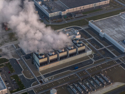 Aerial view of hyperscale data center cooling towers emitting steam, Netherlands