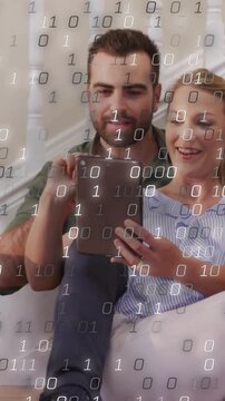 Vertical video: Woman tapping tablet, causing binary overlay growing over partners in tech demo