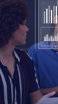 Vertical video: Presenter holding pages activating HUD charts for business while colleague nodding