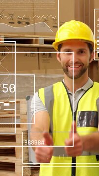 Vertical video: Camera pulling back shipper in hard hat vest giving thumbs up HUD confirming order