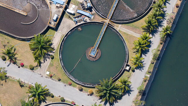 Aerial view of Muang Phuket Municipal Water Quality Development with circular sedimentation tanks and palm trees in Amphoe Mueang Phuket, Chang Wat Phuket, Thailand.