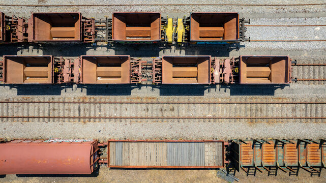Aerial view of rail wagons resting on parallel tracks, their weathered surfaces hinting at journeys past, Vila Nova de Gaia, Portugal.