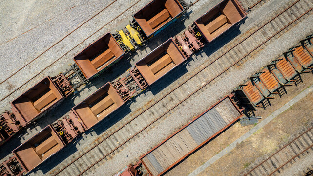 Aerial view of freight train cars with muted tones and textures on parallel tracks, Vila Nova de Gaia, Porto District, Portugal.