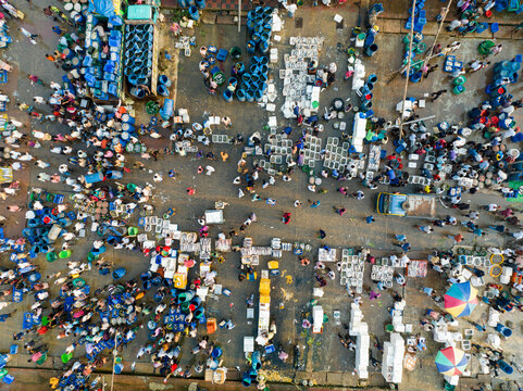 Aerial view of a bustling marketplace filled with vibrant colors and textures, where crowds gather amidst a sea of goods, Chattogram, Chittagong Division, Bangladesh.