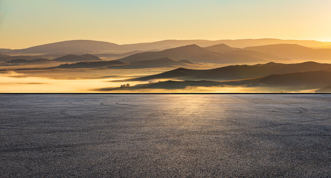 Empty asphalt square ground and mountain nature landscape at sunrise