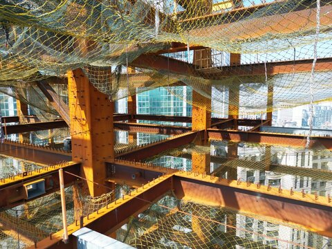 Detailed interior of a steel skyscraper structure with safety nets.