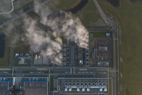 Aerial view of data center with multiple cooling towers releasing steam into the atmosphere, Netherlands