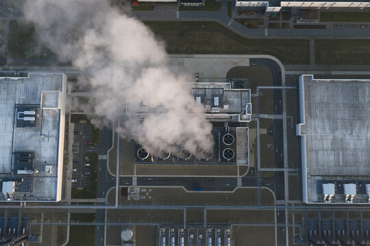 Aerial view of industrial cooling towers emitting exhaust creating pollution