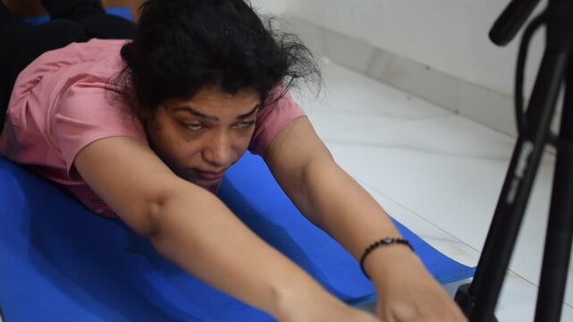 Young Indian woman practicing yoga indoor by online yoga session, Beautiful girl practice basic yoga pose, Asian Indian lady doing indoor yoga