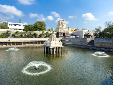 Temple tank with mandapam and fountains at Kamakshi Amman Temple in Kanchipuram, Tamil Nadu, India.