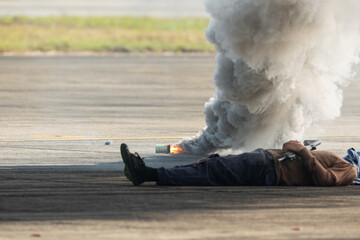 Naklejka premium Selective smoke from smoke bomb and out of focus terrorist lies dead during military assault drill.The criminal was killed by riot police.A drill simulating a rescue operation against terrorists