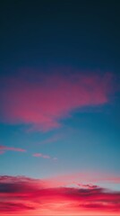 Fototapeta premium Sunset sky with vibrant pink and blue clouds creating a colorful and dramatic natural background. Beautiful evening or morning light