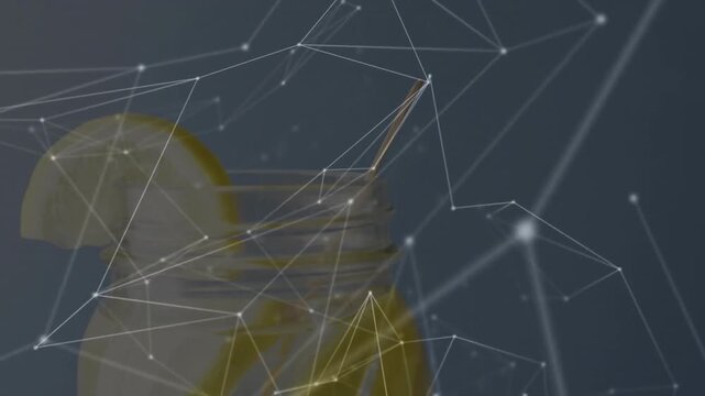 Glass jar featuring yellow liquid, lemon wedge on rim and honey dipper showing network overlay