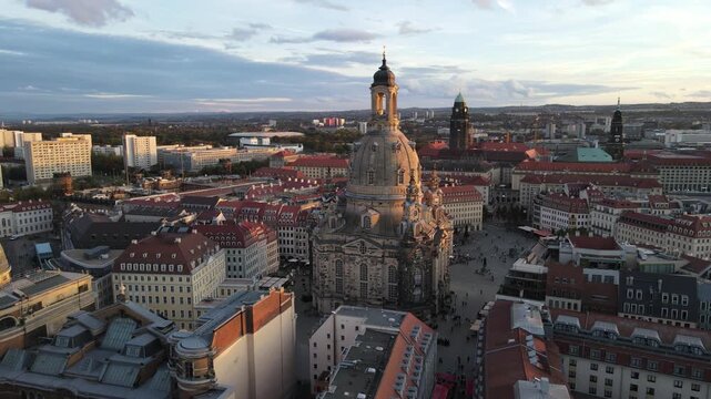 Golden hour orbit around Dresden Frauenkirche above the skyline