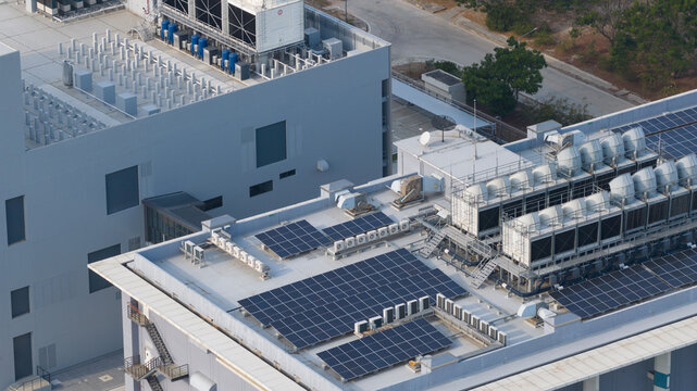 Aerial view of NTT Global Data Centers Thailand Limited featuring solar panels and industrial cooling systems on the rooftop in Tambon Don Huaro, Chang Wat Chon Buri, Thailand.