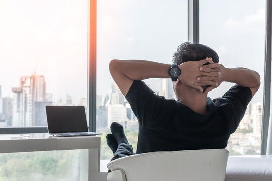 Work-life balance and living life style concept of businessman relaxing, take it easy in hotel or office room resting with thoughtful mind thinking of lifestyle quality looking forward to city