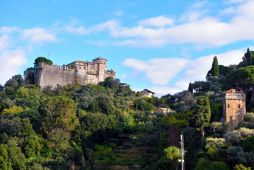 Obraz premium brown castle in Portofino, an ancient defensive fortress located on a promontory overlooking the famous Ligurian bay