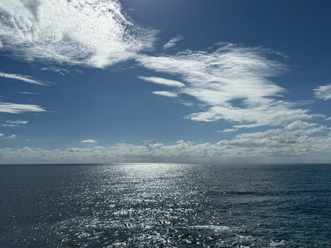 Glittering ocean and beautiful blue sky with clouds.