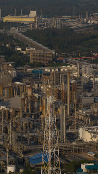 Aerial view of the Map Ta Phut Industrial Estate featuring complex refinery towers, industrial piping, and storage facilities under soft daylight in Map Ta Phut, Rayong, Thailand.