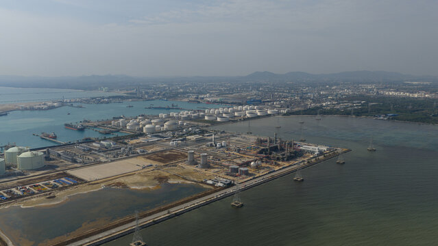 Aerial view of the Map Ta Phut Industrial Estate with storage tanks and industrial infrastructure along the coast Map Ta Phut, Rayong, Thailand.