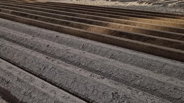 a tractor pulling hiller, which is an agricultural machine designed to prepare soil and create hills, most often for growing potatoes or vegetables, Ridge shaping machine is equipped with shaping plat