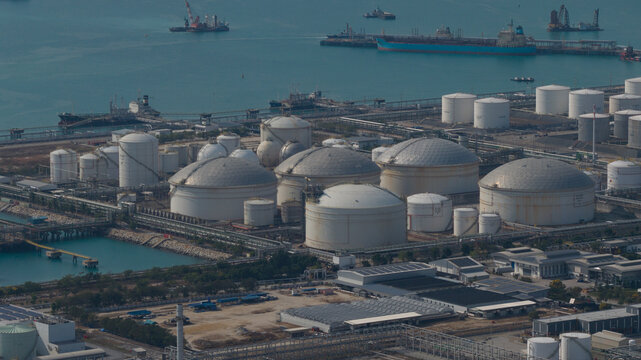 Aerial view of Map Ta Phut Industrial Estate featuring large storage tanks and industrial facilities near the coast Map Ta Phut, Rayong, Thailand.