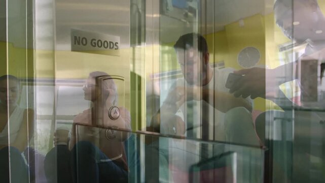 Composite video of group of diverse colleagues discussing together at office against view of office