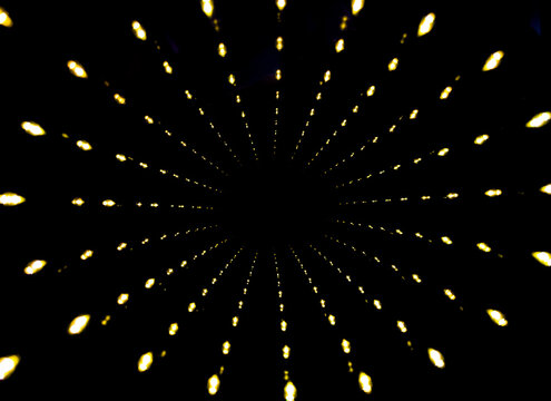 Light beams create a tunnel effect in dark space with bright points