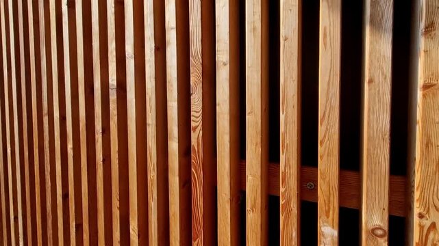 vertical wood slat installation pine or rectangular timber battens mounted with consistent spacing. dark background slats high-contrast, modern shadow gap effect. Acoustic Panels: When backed with fel