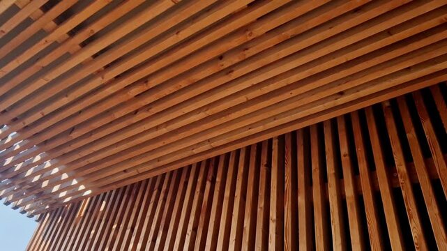 vertical wood slat installation pine or rectangular timber battens mounted with consistent spacing. dark background slats high-contrast, modern shadow gap effect. Acoustic Panels: When backed with fel