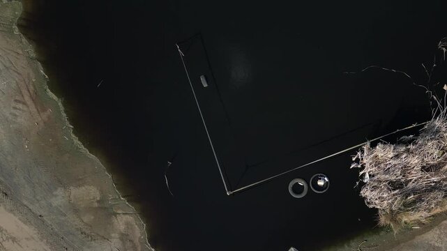 effluent pond or settling basin. Based on visual evidence, Liquid Body Lagoon ​water is extremely dark, almost black, which usually indicates one of two things:
​High Organic Load: Common in food proc