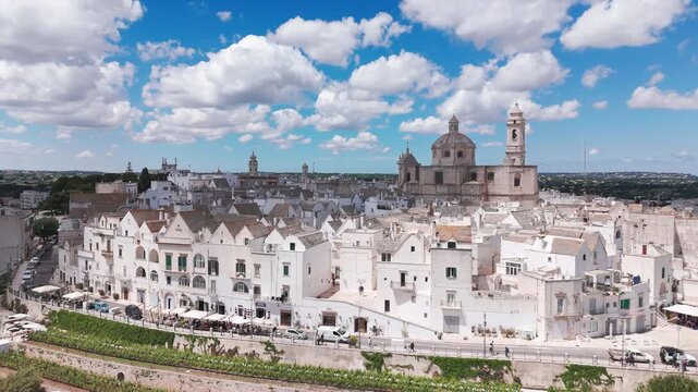 Drone shot of white houses and historic churches in Locorotondo, Southern Italy