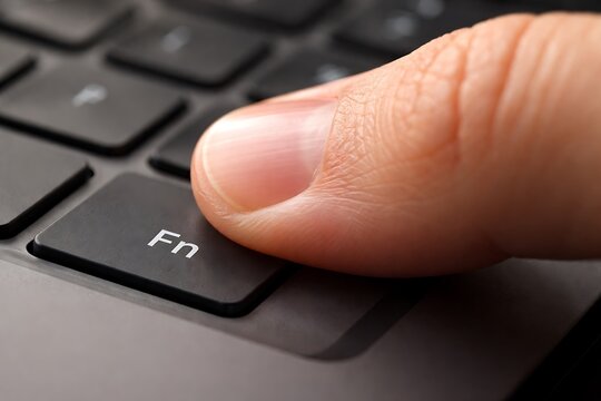 Finger Pressing Fn Key on Laptop Keyboard