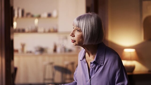 Irritated senior woman shouting at someone at home, expressing distrust