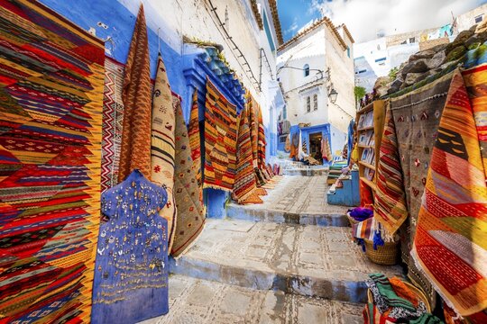 Narrow alley with carpets, carpet dealers, blue houses, medina of Chefchaouen, Chaouen, Tangier-T&eacute;touan, Morocco