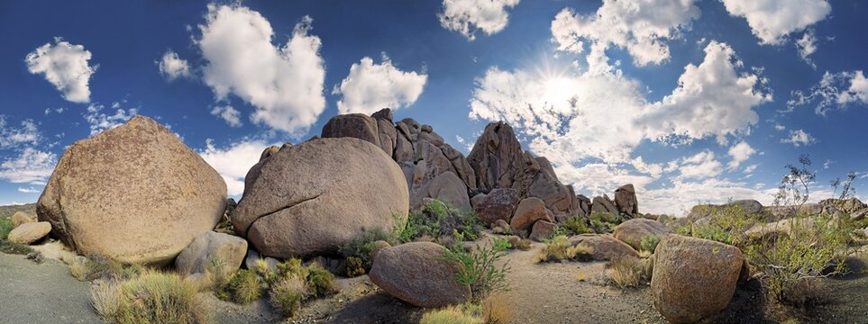Granite rocks of Split Rocks with cumulus clouds, Joshua Tree National Park, Desert Center, California, USA