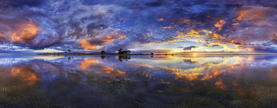 360&deg; x 170&deg; panorama with glorious sunset at Carters Beach, cloudy sky, Water Reflection, Westport, West Coast, Southland, New Zealand