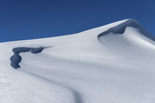 Snow drift with snow cornice, snow surface with structures with light and shade, Rietzlern, Kleinwalsertal, Vorarlberg, Austria
