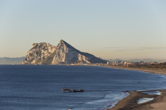 View of The Rock of Gibraltar and La Linea de la Concepcion as seen from the Mediterranean coast in the early morning light, Cadiz, Andalusia, Spain