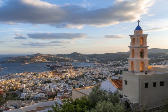 View from Ano Syros to houses of Ermoupoli, church in evening light, sea with islands, Ano Syros, Syros, Cyclades, Greece