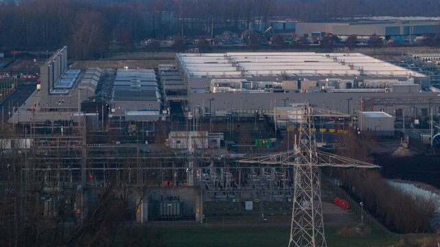 Aerial view of the Datacenter Winschoten featuring a large industrial facility and electrical substation with power lines Winschoten, Groningen, Netherlands.