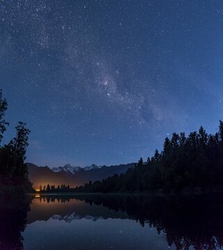 View of Mount Cook and Mount Tasman with starry sky and Milky Way, reflection in Lake Matheson, Westland National Park, New Zealand Alps, West Coast Region, South Island, New Zealand