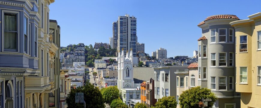 Saint Francis of Assisi Church and historic wooden buildings on Vallejo Street, San Francisco, California, USA