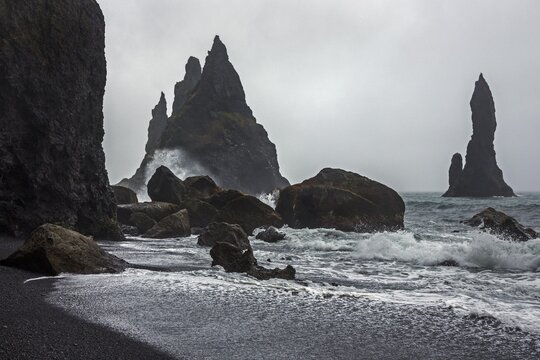 Lava rocks and rock needles at the black lava beach Reynisfjara, near Vik, South Iceland, Iceland