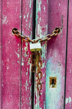 Lock on a chain, wood door